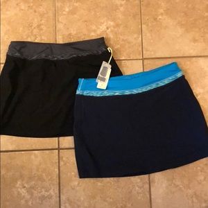 TWO tangerine skorts